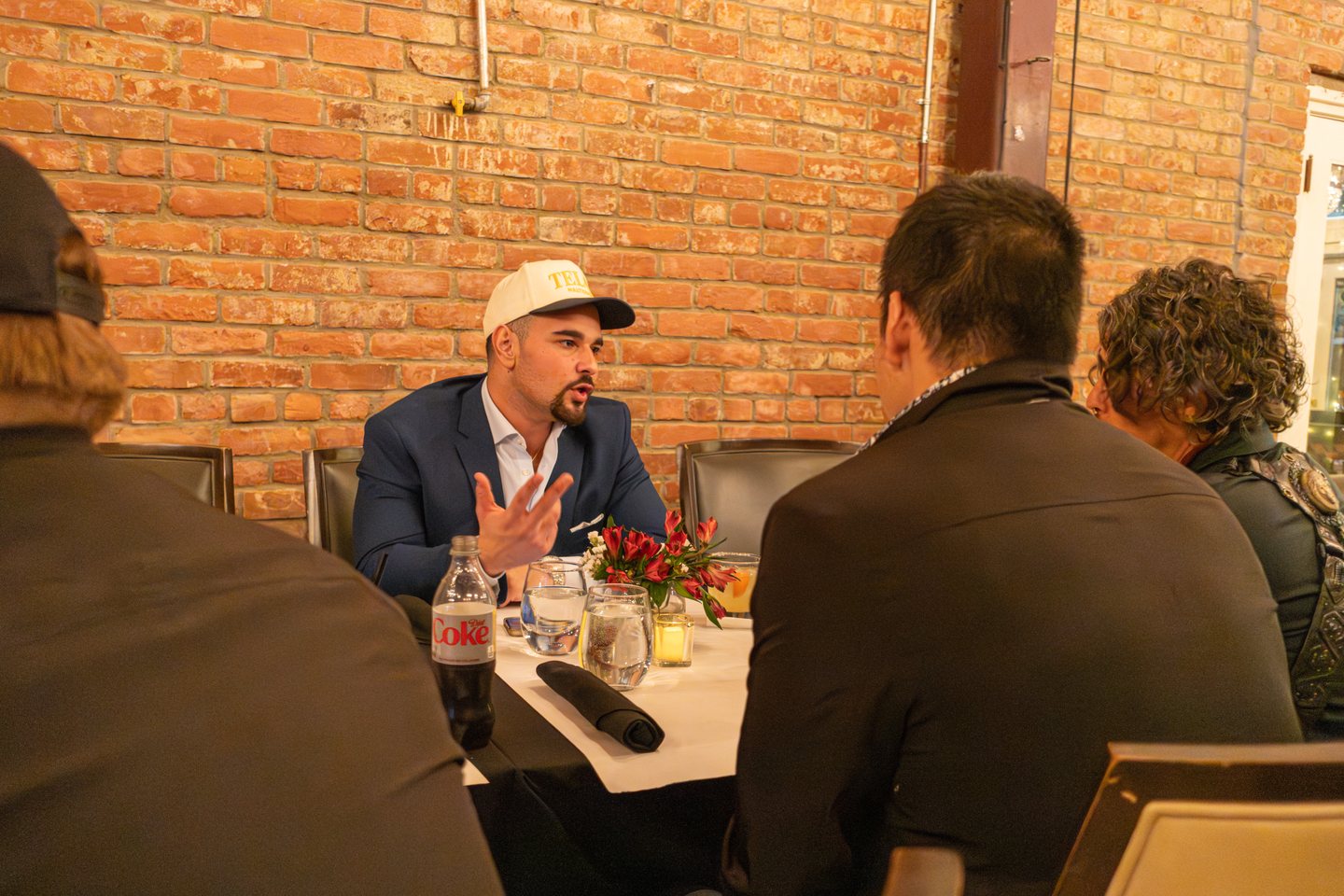 A small-group conversation over dinner at the March 2026 TELŌS event
